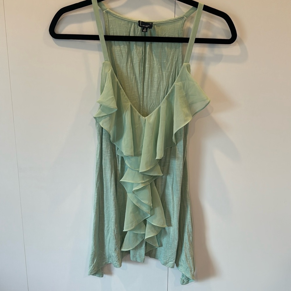 Green tank top with frills on the front and v cut.